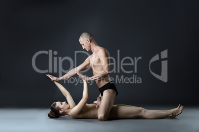 Nude paired yoga. Man in lotus position on woman