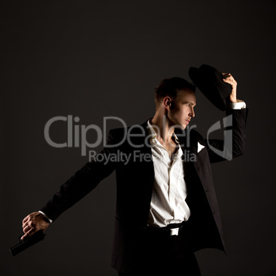 Handsome male dancer posing in gangster suit