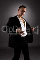 Strip dance. Attractive man in suit with stripes