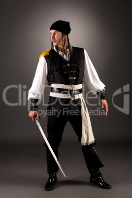 Daring pirate with saber. Photo on gray background