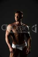 Handsome muscular male model posing in underwear