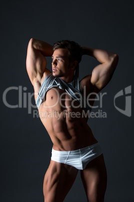 Image of hot blue-eyed bodybuilder shows his body