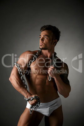 Male model posing with chain wrapped around neck