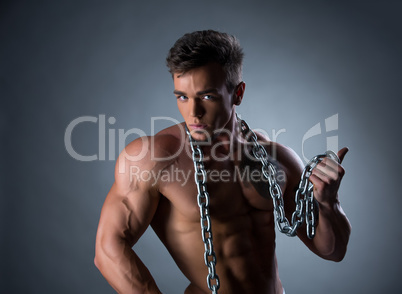 Sexy bodybuilder posing with chain around his neck