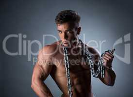Sexy bodybuilder posing with chain around his neck