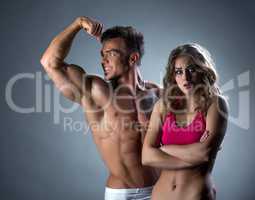Man admiring biceps and his girlfriend outraged