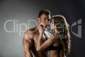 Loving woman admires sexy tanned bodybuilder