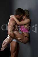 Beautiful couple embracing passionately in studio