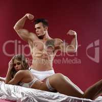 Impressive couple - strong man and sensual model