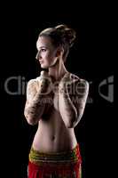 Sensual topless woman with henna pattern on hands