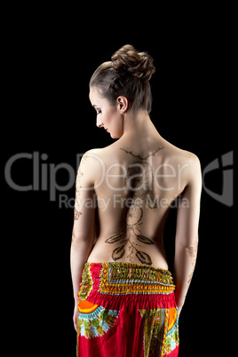 Mehendi. Shot of woman's back painted with henna