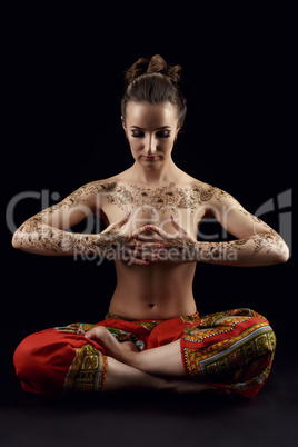Yoga. Woman's body covered with floral patterns