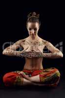 Yoga. Woman's body covered with floral patterns