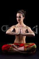 Mehendi. Pretty woman meditating in lotus position