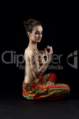 Yoga and mehndi. Beautiful topless woman meditates