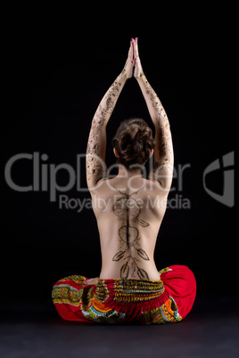 Yoga and mehndi. Image of topless woman meditating