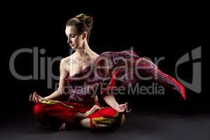 Beautiful calm woman meditates in lotus position