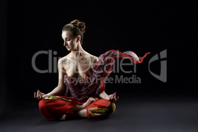 Yoga. Sensual woman meditating in lotus position