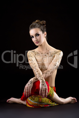 Topless woman with mehendi on chest and shoulders