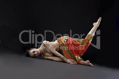 Mehendi and yoga. Studio shot of woman doing asana