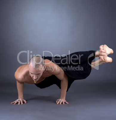 Studio photo of middle-aged man practicing yoga