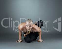 Yogi performs asana. Studio shot, on gray backdrop