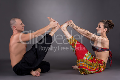 Practice yoga in pair. Image on grey background