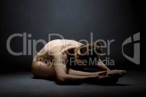 Naked model in pose of stretching. Studio photo