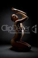 Image of naked dancer froze in elegant posture