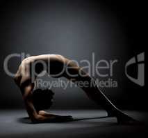 Nude yoga. Image of woman in stretching posture