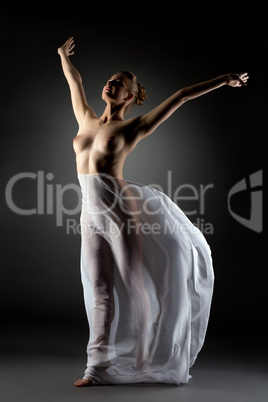 Graceful modern dancer posing naked in studio