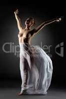 Graceful modern dancer posing naked in studio