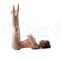 Side view of naked girl stretching her legs up