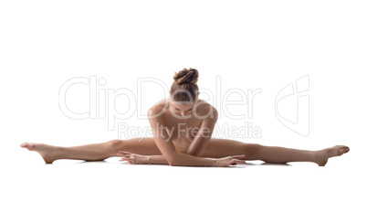 Nude female athlete doing gymnastic split