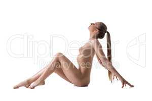 Nude girl with long hair gathered in ponytail