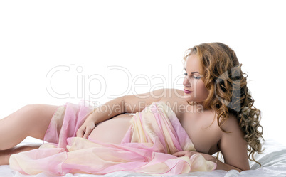 Sensual seminude pregnant woman posing in studio