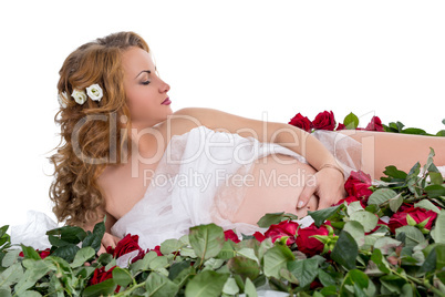 Sensual expectant mother posing with roses
