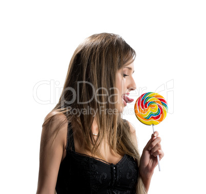 Image of sexy young brunette licking lollipop