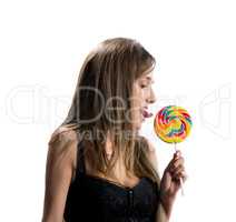 Image of sexy young brunette licking lollipop