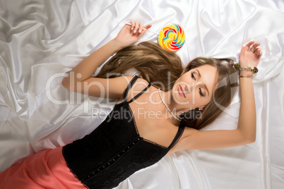 Top view of sexy young coquette with lollipop