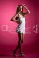 Sexy girl posing in nightgown, on pink background