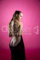 Back view of nude beauty posing with black cloth