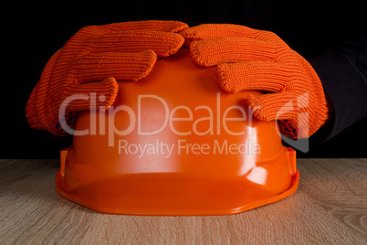 Orange construction helmet in hands