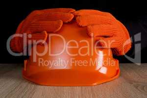 Orange construction helmet in hands