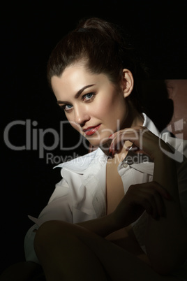 Attractive woman wearing blouse on naked body
