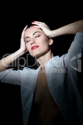 Sexy girl in blouse posing while holding her head