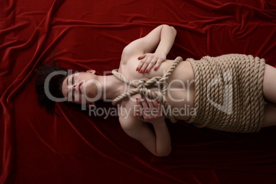 Bondage as sexual fetish. Woman tied with rope