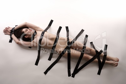 BDSM. Nude woman with duct tape on her body