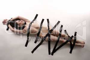 BDSM. Nude woman with duct tape on her body