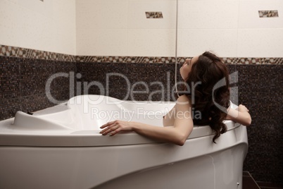 Image of nude brunette enjoys taking bath
